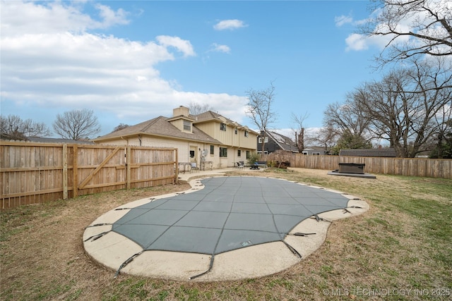 view of pool featuring a yard, a fenced in pool, a fenced backyard, and a patio