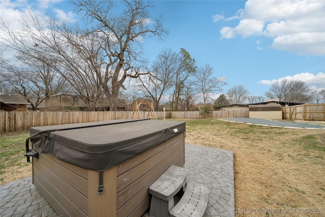 view of yard featuring a hot tub and a fenced backyard