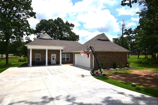 view of front of home featuring an attached garage, driveway, and brick siding