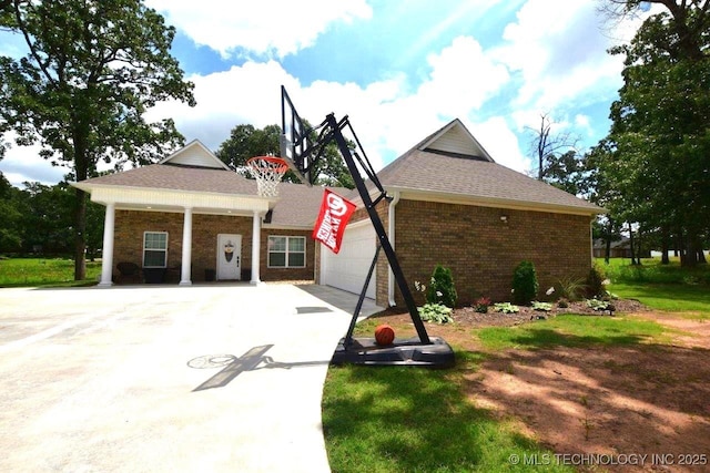 view of front facade with a garage, concrete driveway, and brick siding