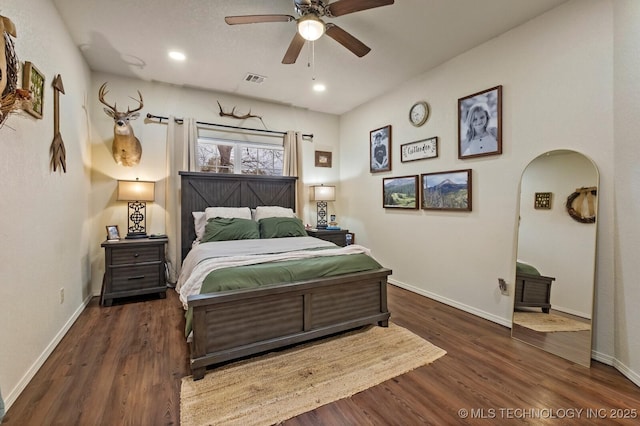 bedroom featuring arched walkways, recessed lighting, visible vents, wood finished floors, and baseboards