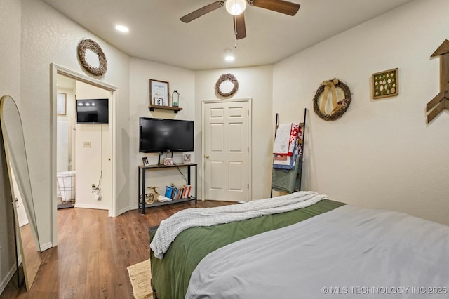 bedroom with recessed lighting, wood finished floors, a ceiling fan, and baseboards