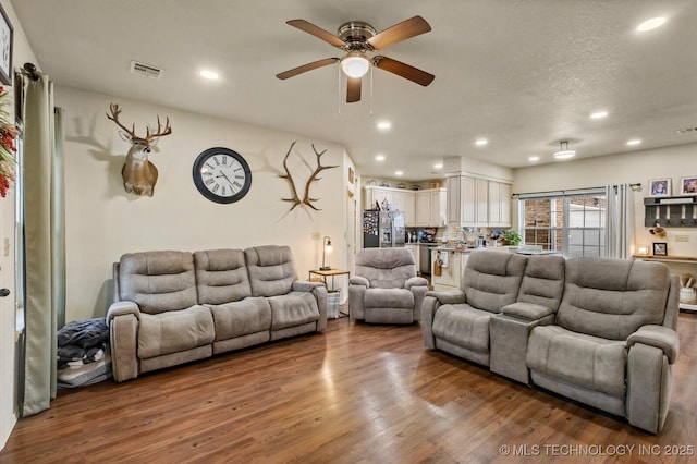 living room featuring recessed lighting, visible vents, ceiling fan, and wood finished floors