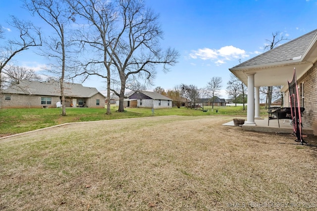 view of yard featuring a residential view and a patio