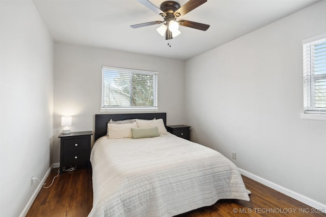 bedroom with a ceiling fan, baseboards, and wood finished floors