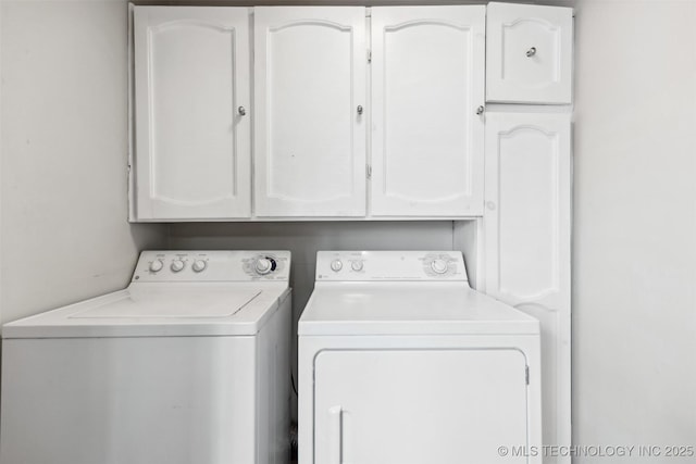 laundry area featuring cabinet space and washing machine and clothes dryer