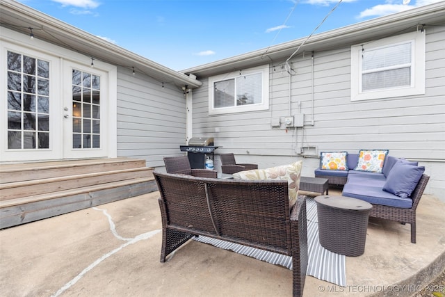 view of patio featuring an outdoor living space, area for grilling, and french doors