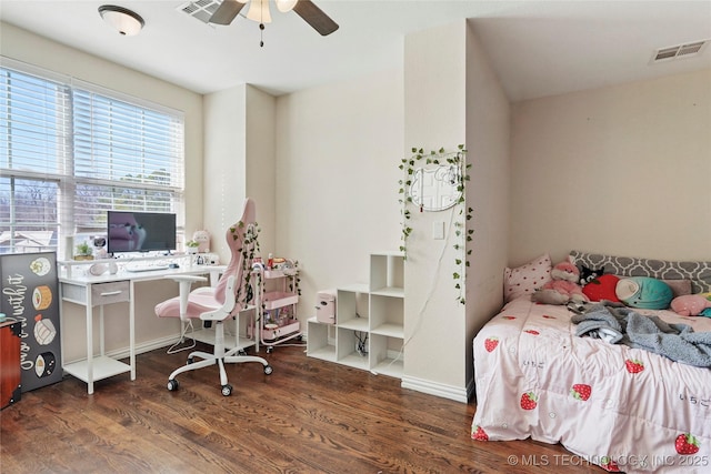 bedroom featuring a ceiling fan, wood finished floors, visible vents, and baseboards