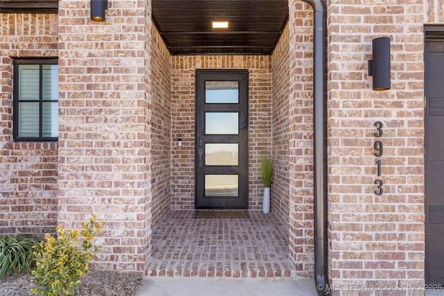 entrance to property with brick siding