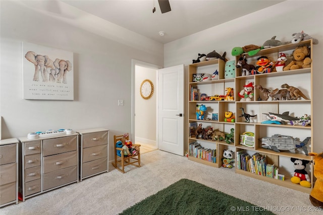 recreation room with ceiling fan and carpet flooring