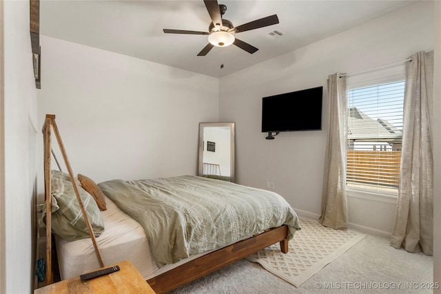 carpeted bedroom featuring baseboards, visible vents, and a ceiling fan