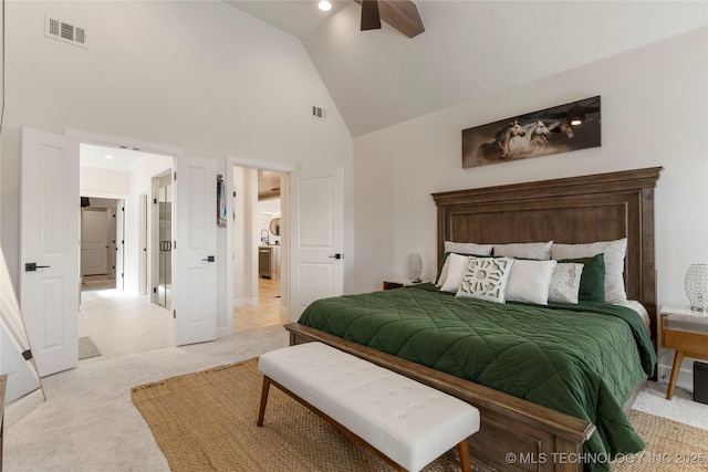 bedroom featuring light carpet, high vaulted ceiling, visible vents, and a ceiling fan