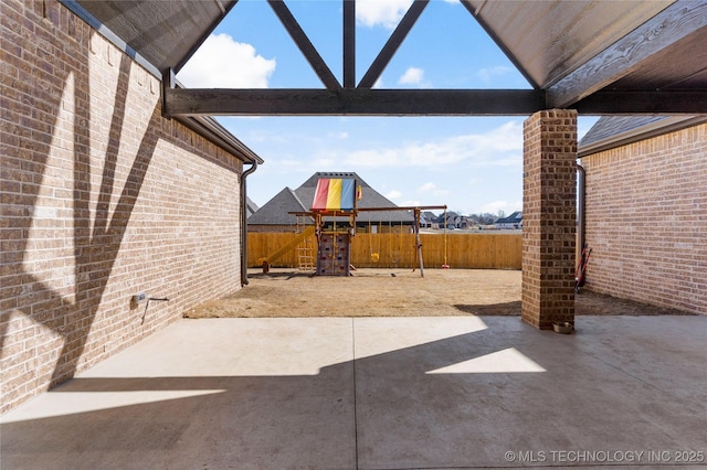 view of patio / terrace with a fenced backyard and a playground