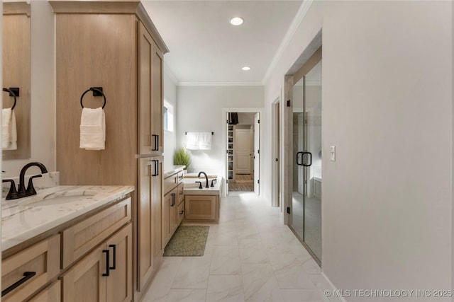 full bathroom with a stall shower, ornamental molding, marble finish floor, a sink, and recessed lighting