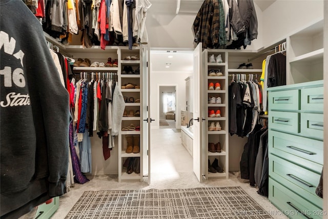 spacious closet featuring carpet flooring