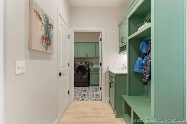 mudroom with washer / clothes dryer, light wood-type flooring, and a sink