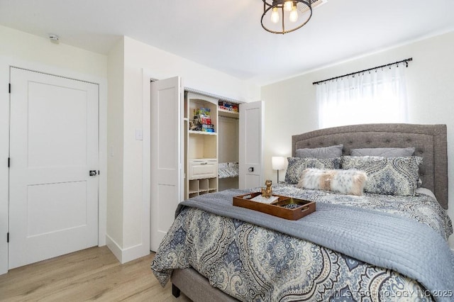 bedroom with a closet and wood finished floors