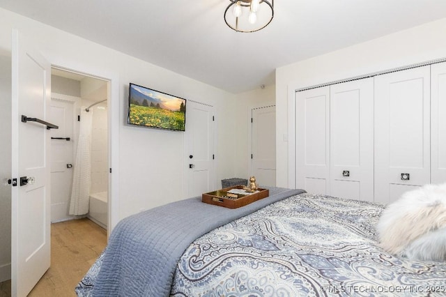 bedroom with light wood finished floors and a closet