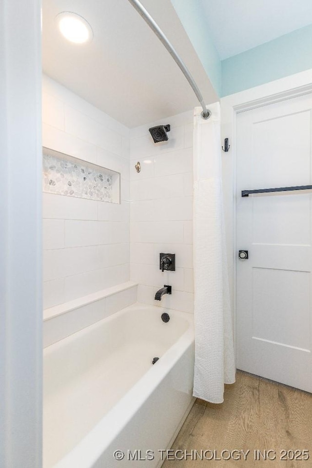 full bath featuring shower / bath combination with curtain and wood finished floors