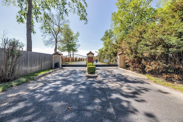 view of road with a gated entry and a gate