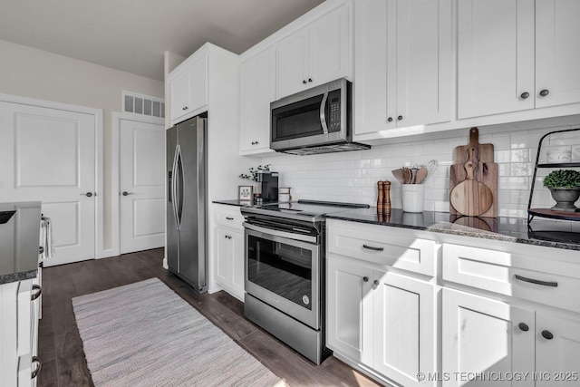 kitchen with white cabinets, visible vents, and stainless steel appliances