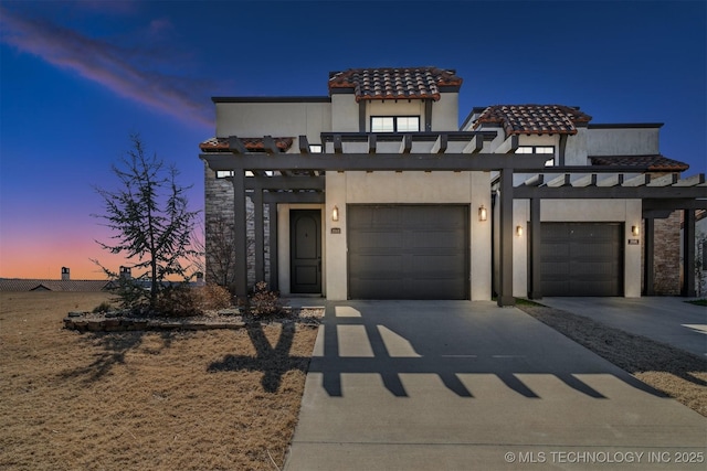 view of front of property featuring concrete driveway and stucco siding