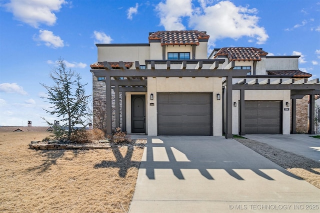 view of front of house featuring concrete driveway, a tile roof, and stucco siding