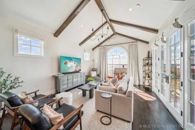 living area featuring a wealth of natural light, lofted ceiling with beams, baseboards, and wood finished floors