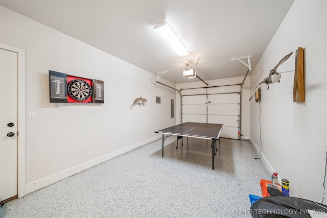 game room with a garage, baseboards, and speckled floor