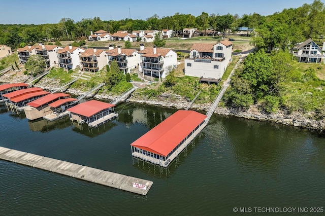 drone / aerial view featuring a residential view and a water view