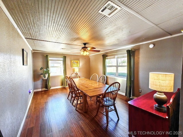 dining room featuring a textured wall, hardwood / wood-style floors, and visible vents