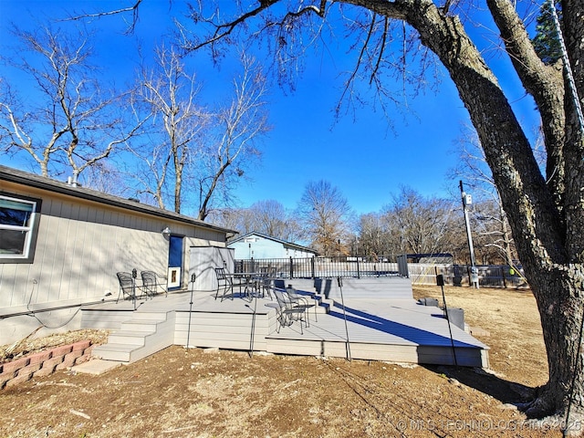 view of property's community with fence and a wooden deck