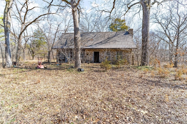 view of front facade with metal roof and stone siding