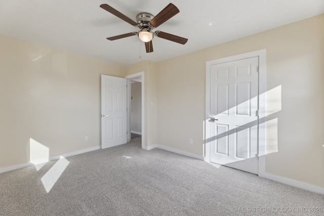 interior space featuring carpet, baseboards, and a ceiling fan