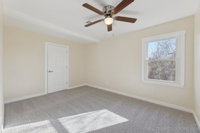 carpeted empty room featuring baseboards, visible vents, and a ceiling fan