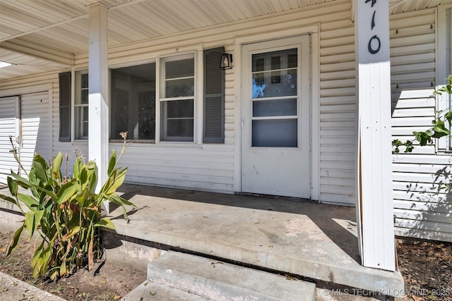 view of exterior entry featuring a porch