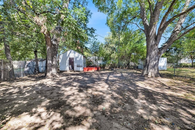 view of yard with an outbuilding and a fenced backyard