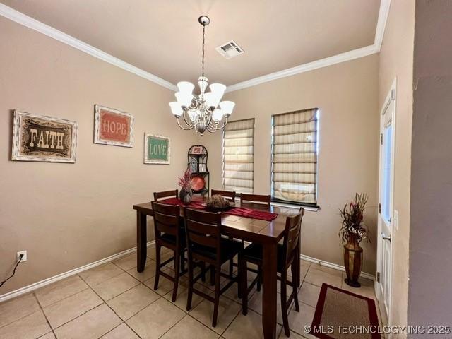 dining space featuring baseboards, visible vents, crown molding, a chandelier, and light tile patterned flooring