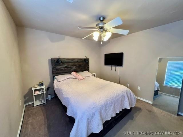 carpeted bedroom featuring a ceiling fan and baseboards