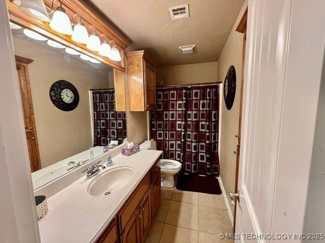 full bath featuring toilet, visible vents, vanity, and tile patterned floors