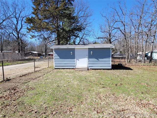 view of shed featuring fence