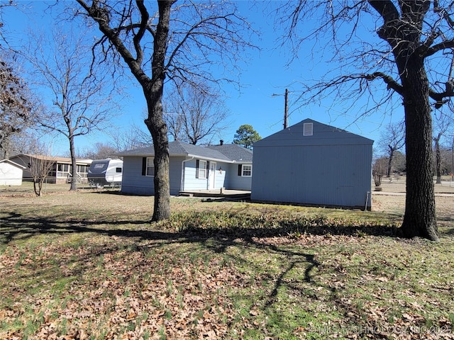 exterior space with an outbuilding, a storage unit, and a lawn
