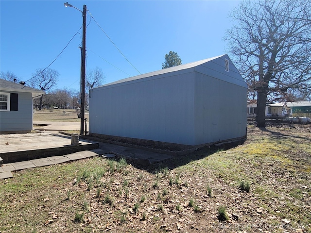 exterior space featuring a wooden deck and an outdoor structure