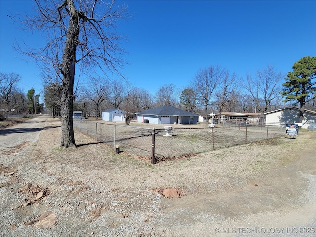 view of yard featuring a garage and fence