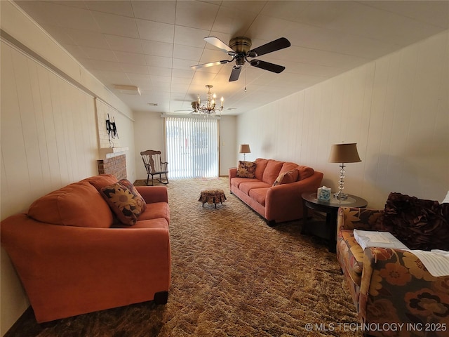 living room with ceiling fan with notable chandelier and carpet floors