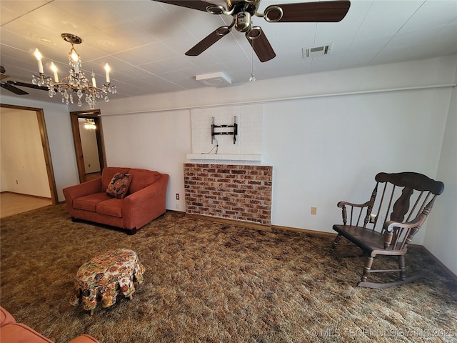living area with visible vents, carpet flooring, and ceiling fan with notable chandelier