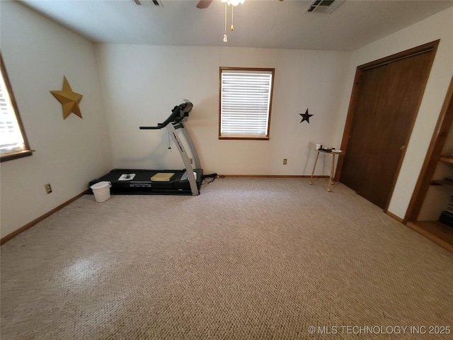 exercise area featuring light carpet, baseboards, visible vents, and a ceiling fan