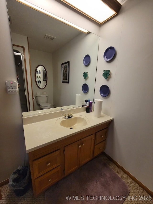 bathroom with toilet, visible vents, baseboards, and vanity