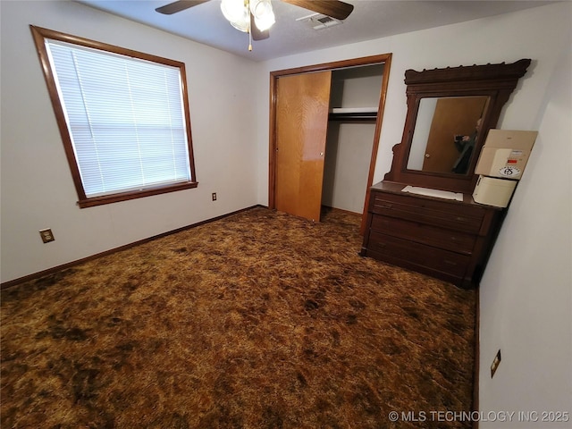 unfurnished bedroom with baseboards, visible vents, ceiling fan, carpet floors, and a closet