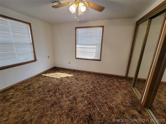unfurnished bedroom featuring a closet, visible vents, ceiling fan, and baseboards